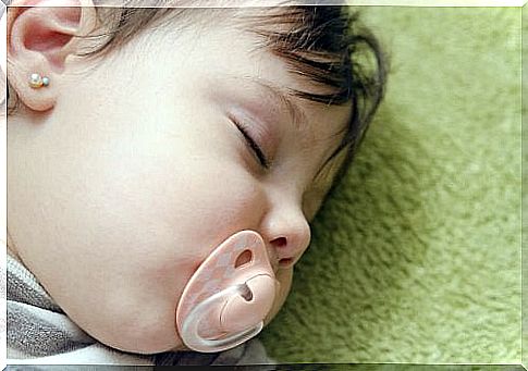 little girl sleeping with a pacifier