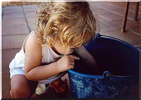 a child is playing and is about to throw everything on the floor